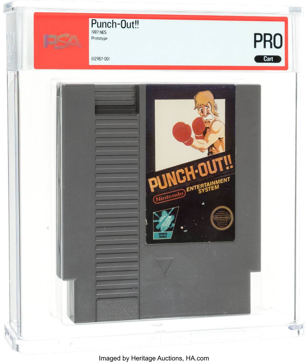 The Punch-Out!! NES prototype cartridge in its PSA holder, a gray shell with a black box style mock-up label showing Glass Joe in red boxing gloves above the Punch-Out!! logo